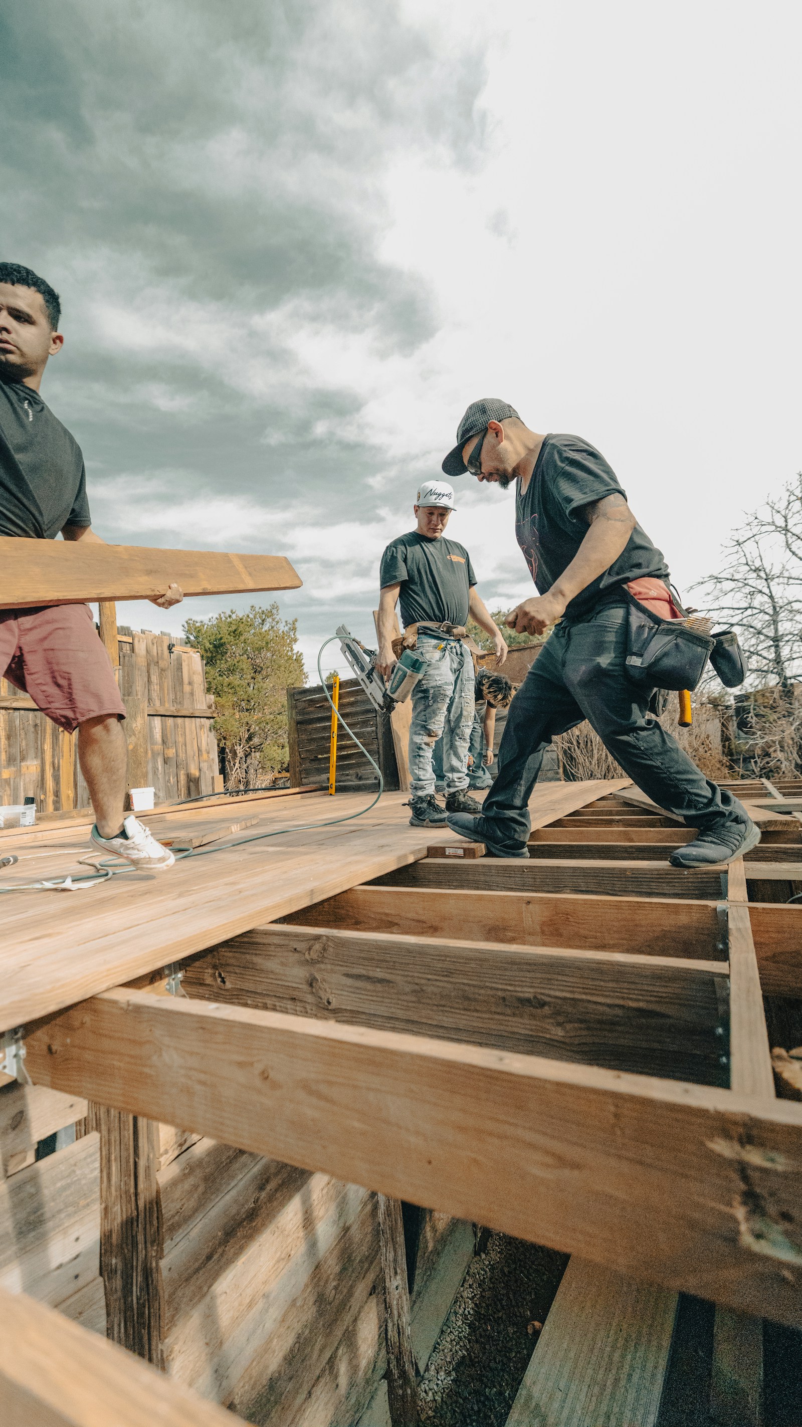 Crew building a raised wooden deck — still on site when the customer wants a number