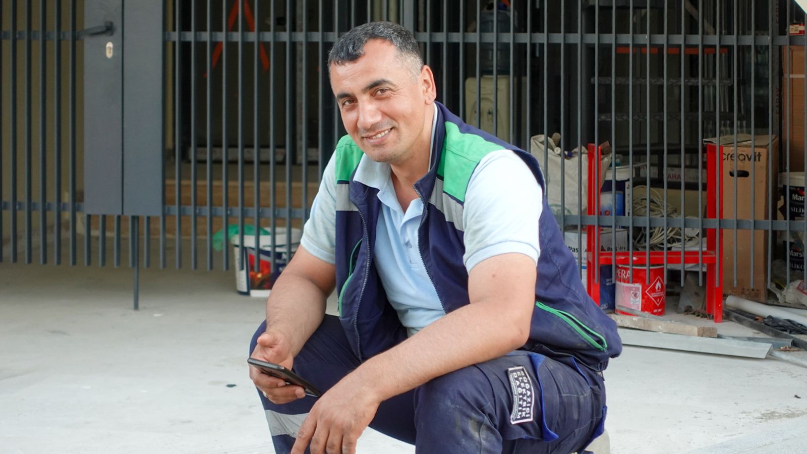 Construction worker sending a quote from his phone